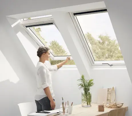 kobieta otwierająca okno dachowe